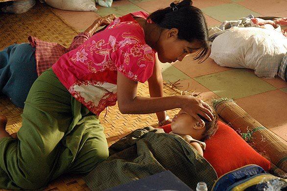 A woman comforts her child at a relief center after fleeing Kyauktan, about 40 miles southeast of Yangon, Myanmar's main city. Tropical Cyclone Nargis, which slammed into the rice-growing Irrawaddy River delta region in the country's south, may be followed by another storm: A tropical depression is building over the Andaman Sea as survivors of the first storm await aid. The government raised the official toll to 29,000.