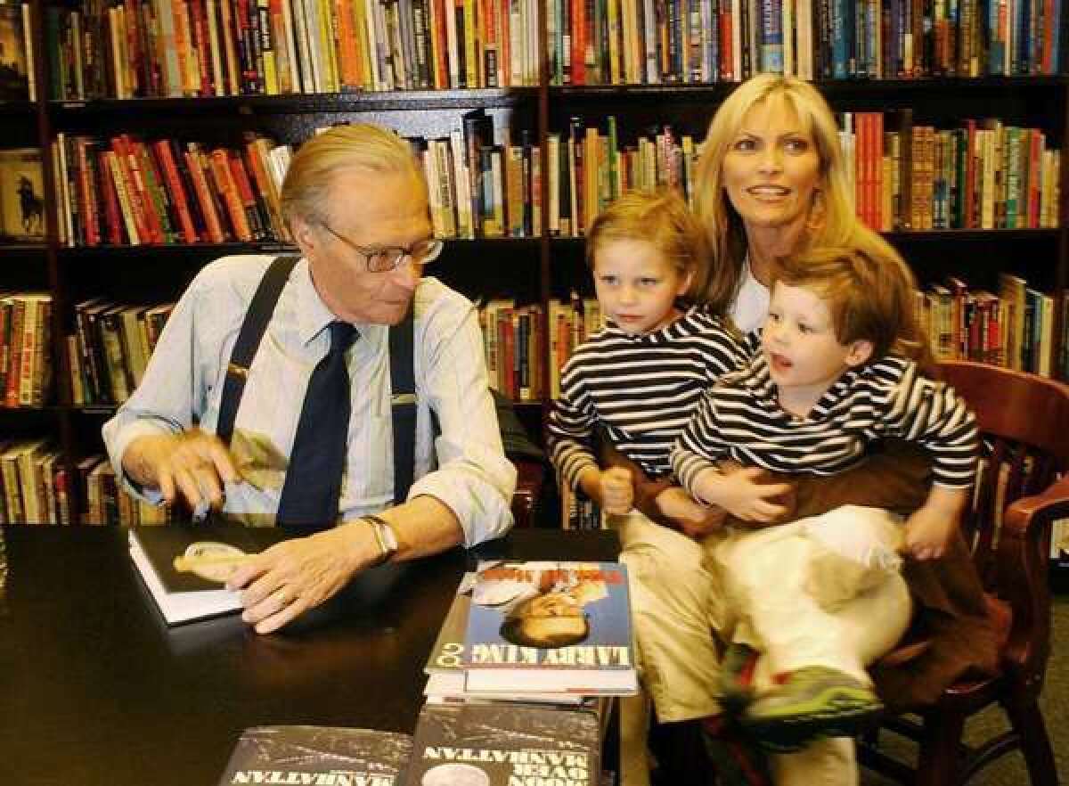 Larry King, pictured with his family at a 2003 book signing, is 26 years older than his wife, Shawn Southwick. A team of researchers believes that men's preferences for younger mates may explain the origin of menopause.