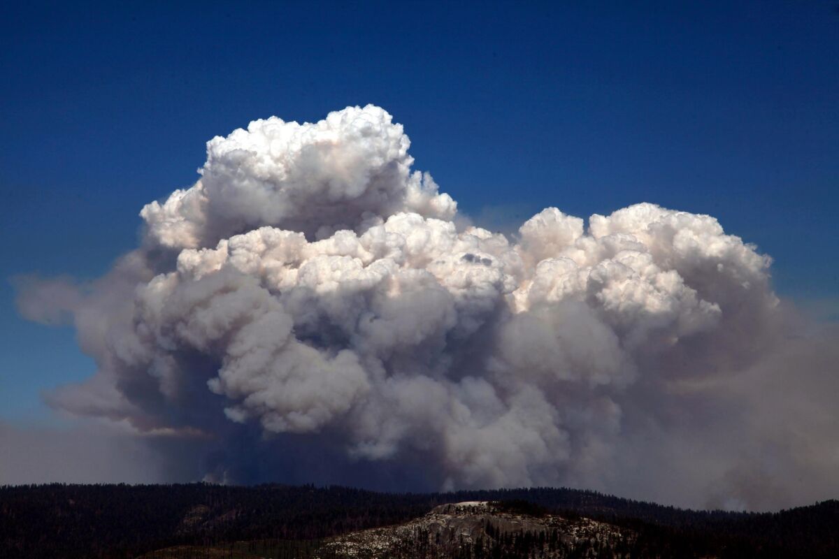 A huge smoke cloud rises into the air in Tuolumne County on Tuesday as the Rim fire continued to rage.