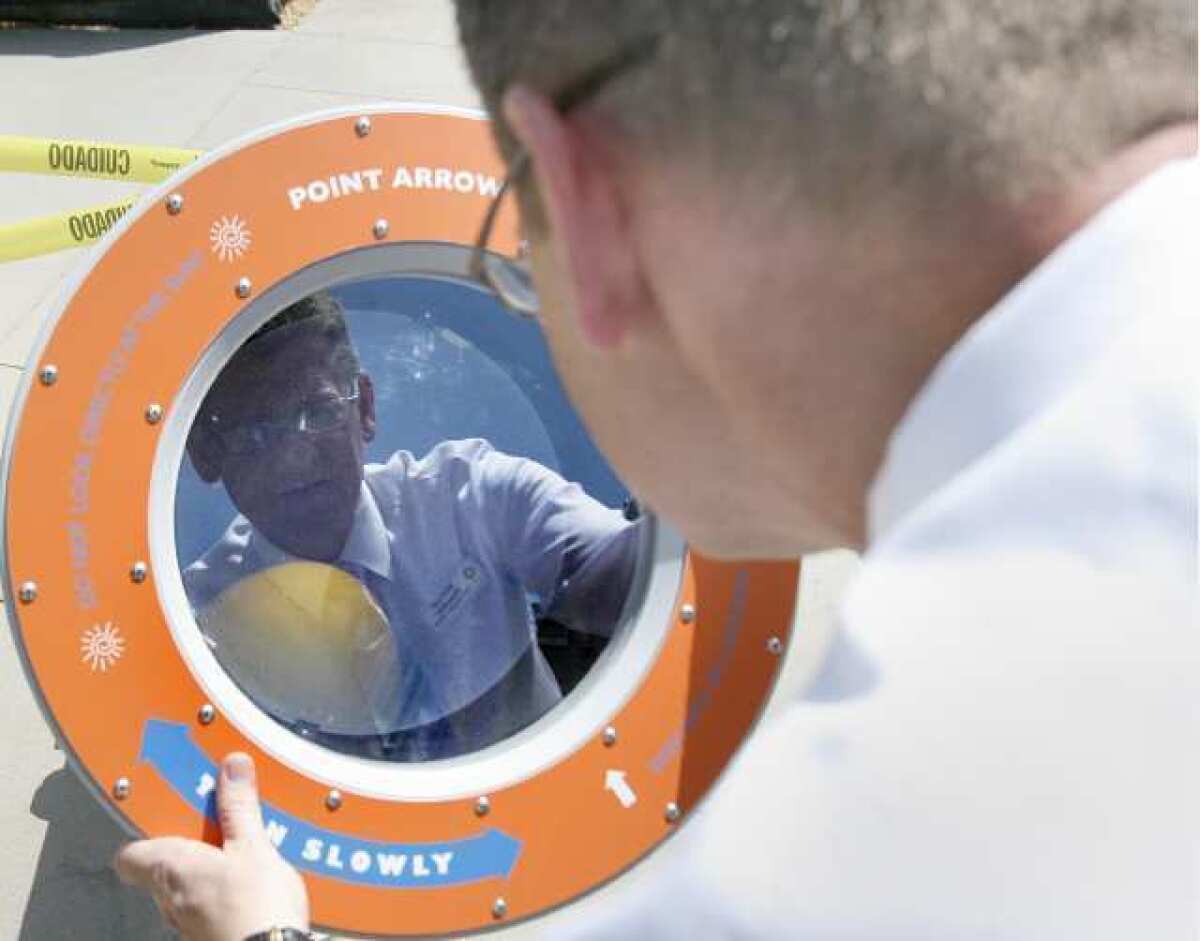 Michael Shanklin, the CEO of Kidspace Children's Museum, plays with the Sun Spotter which allows the user to safely look at a live image of the sun in the Enchanted Physics Forest. The outdoor area is new to Kidspace with several interactive stations that kids can play with to learn about their physical world.