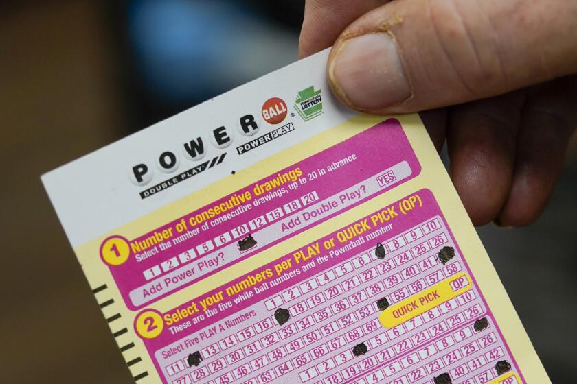 FILE - A person shows his scan card for their personal selection numbers for a ticket for a Powerball drawing on Nov. 7, 2022 in Renfrew, Pa. An $835 million Powerball jackpot will be up for grabs Wednesday, Sept. 27, 2023, for players willing to risk a couple dollars and brave incredibly long odds.(AP Photo/Keith Srakocic, File)