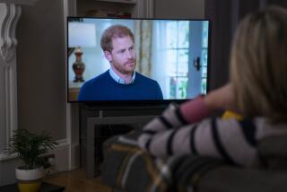 A person at home in Edinburgh watches Prince Harry, the Duke of Sussex, being interviewed by ITV's Tom Bradby during "Harry: The Interview," two days before his controversial autobiography "Spare" is published, Sunday, Jan. 8, 2023. (Jane Barlow/PA via AP)