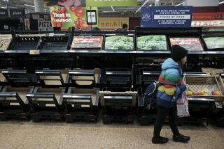A girl walks by empty fruit and vegetable shelves at an Asda in east London, Saturday, Feb. 25, 2023. British people have had to ration tomatoes and cucumbers for the past two weeks amid a shortage of fresh vegetables. Officials blame the problem on recent bad weather in Spain and North Africa, but with other European countries not suffering the same shortages, some people question if Brexit is to blame. (Yui Mok/PA via AP)