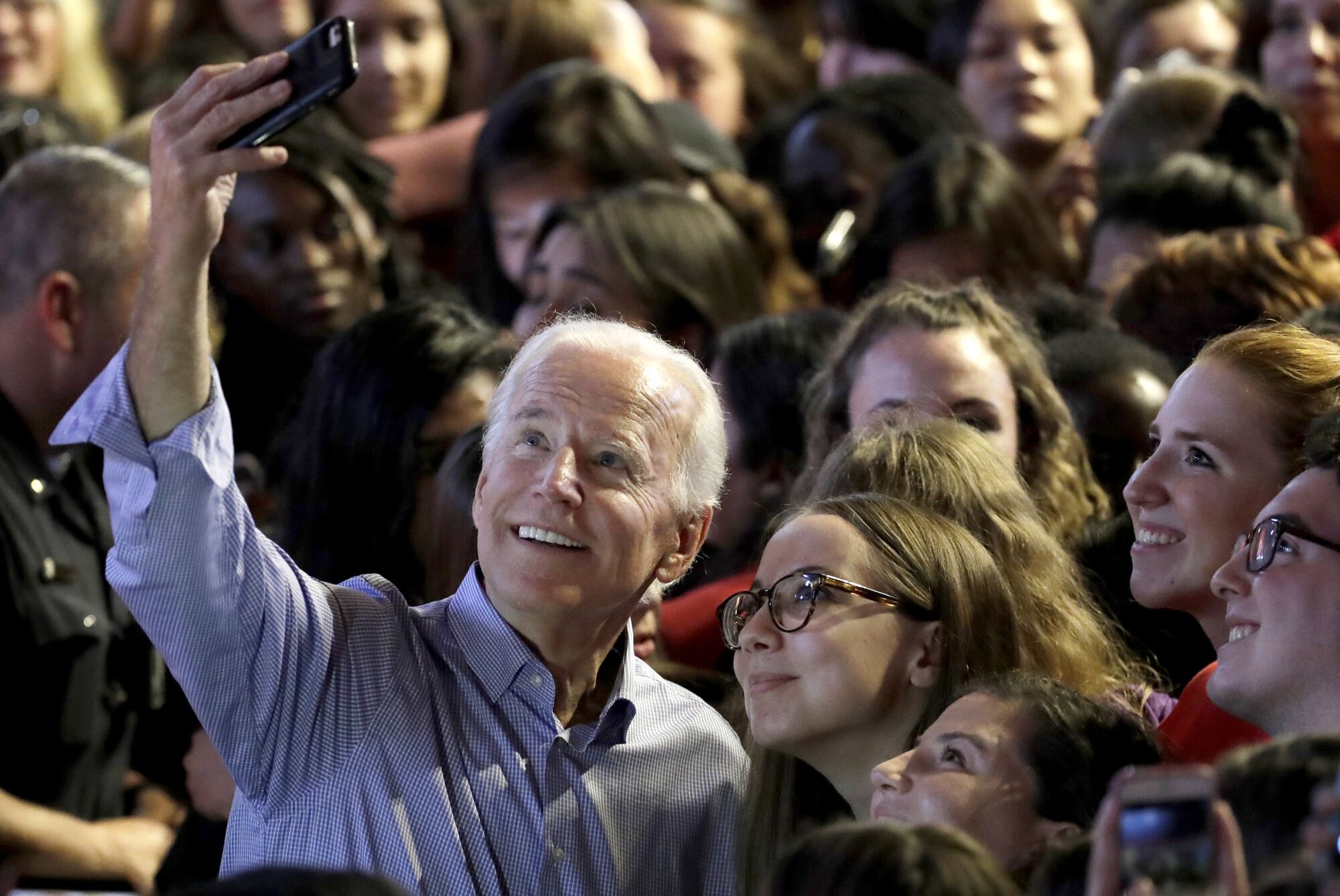 Biden takes a selfie with students at Rutgers University in October 2017.