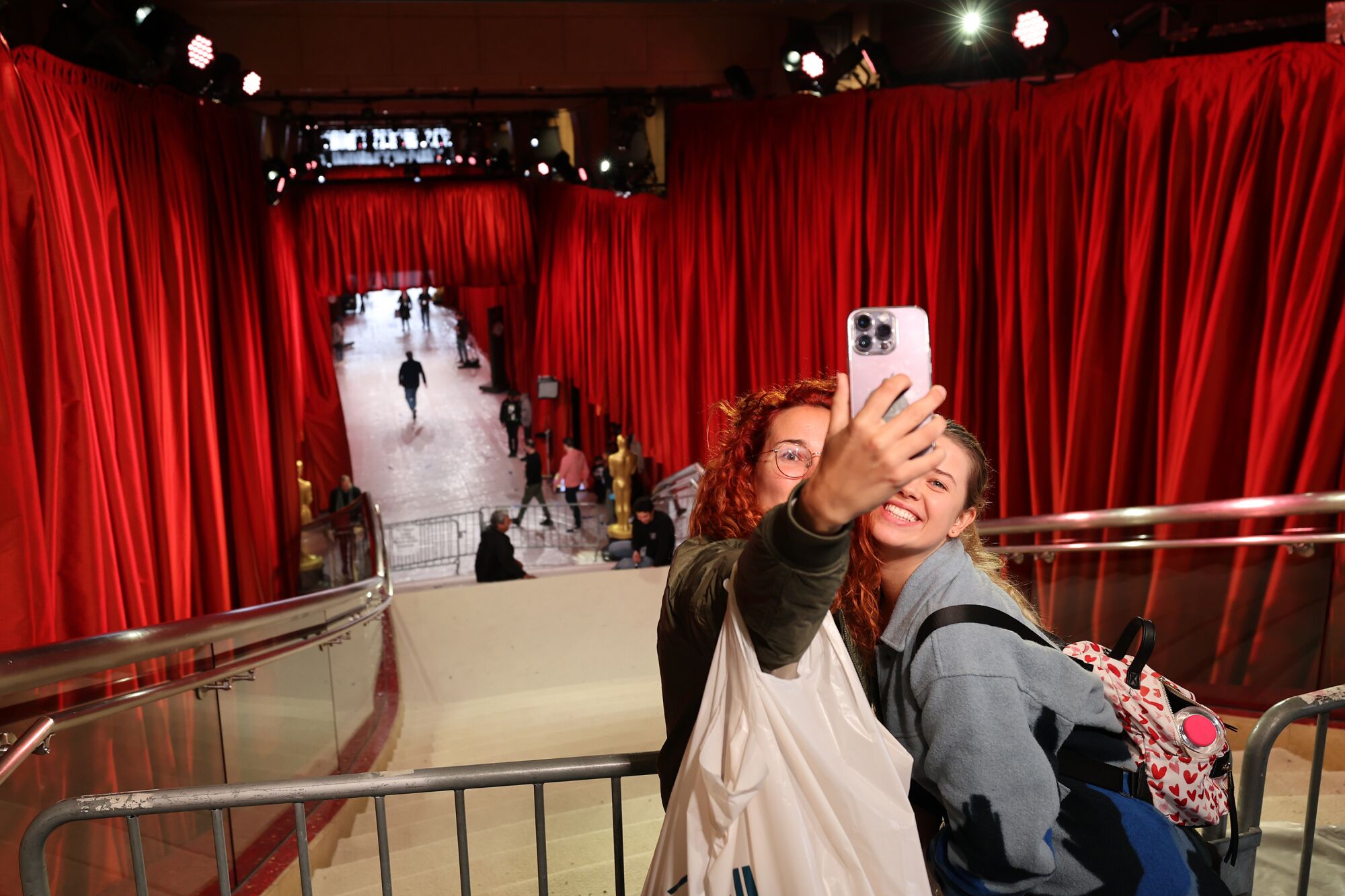 Natalia Krysinska, right and Emma Quiros stop for a selfie as preparations for the 95th Academy Awards 