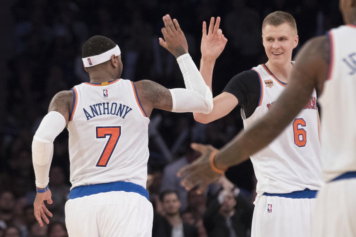 Knicks forward Carmelo Anthony (7) and forward Kristaps Porzingis (6) celebrate after Anthony made a three-point shot during the second half on Nov. 14.