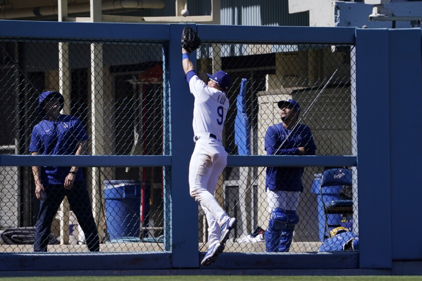 Dodgers left fielder Gavin Lux can't get to a ball hit for an RBI double by the Padres' Luke Voit 