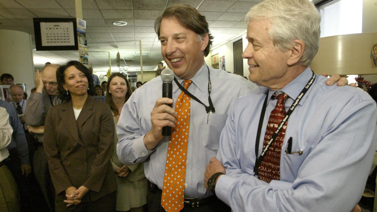 Los Angeles Times Publisher John Puerner, center, and Editor John Carroll celebrate in the newsroom after The Times won two Pulitzer Prizes in 2005.