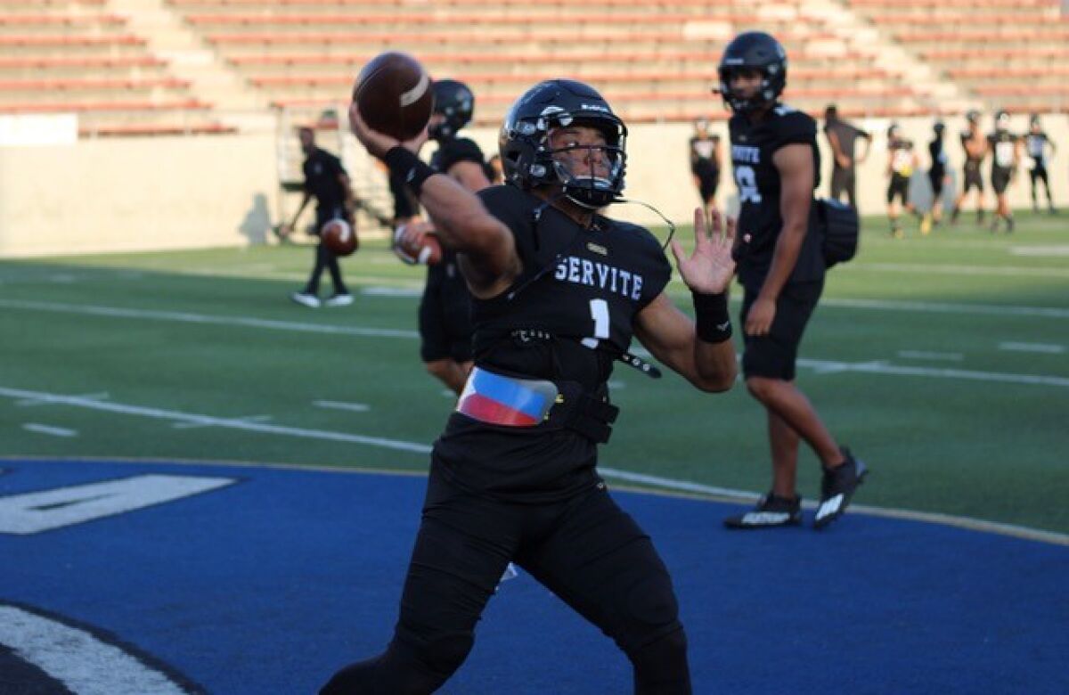 Servite quarterback Noah Fifita warms up before a game against Edison.