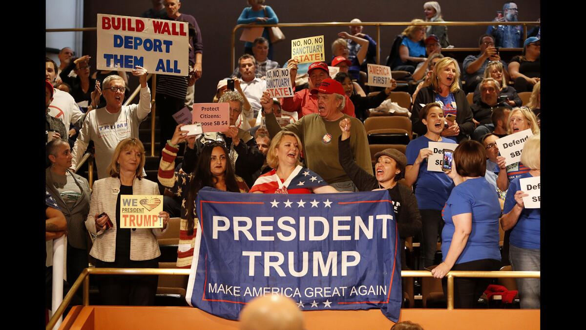 Demonstrators protest California's “sanctuary state” law during a Huntington Beach City Council meeting in April 2018.