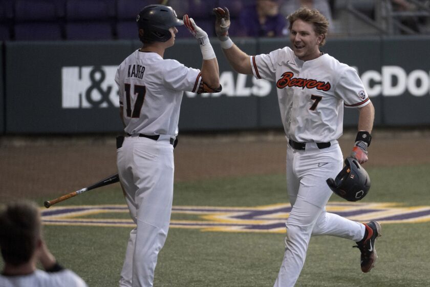 Oregon State's Mikey Kane (7) celebrates with right fielder Brady Kasper (17) after scoring against Sam Houston State during an NCAA college baseball tournament regional game Friday, June 2, 2023, in Baton Rouge, La. (Hilary Scheinu/The Advocate via AP)