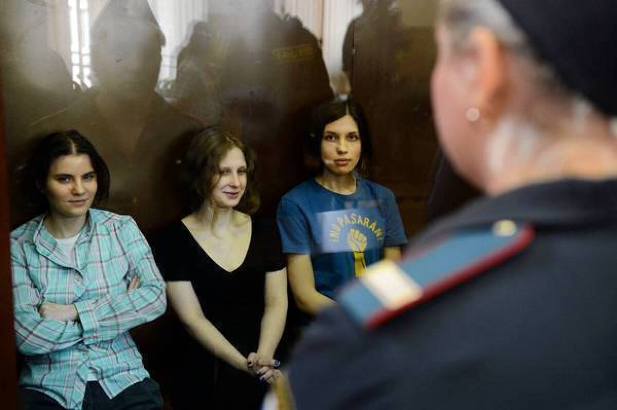 Members of the all-girl punk band Pussy Riot: sit in a glass-walled cage during a court hearing in Moscow on Aug. 17, 2012.