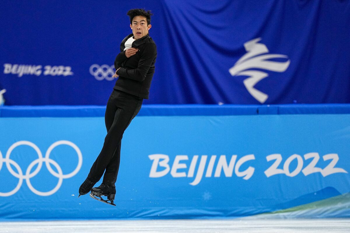 Nathan Chen, of the United States, competes during the men's singles short program team event in the figure skating competition at the 2022 Winter Olympics, Friday, Feb. 4, 2022, in Beijing. (AP Photo/David J. Phillip)