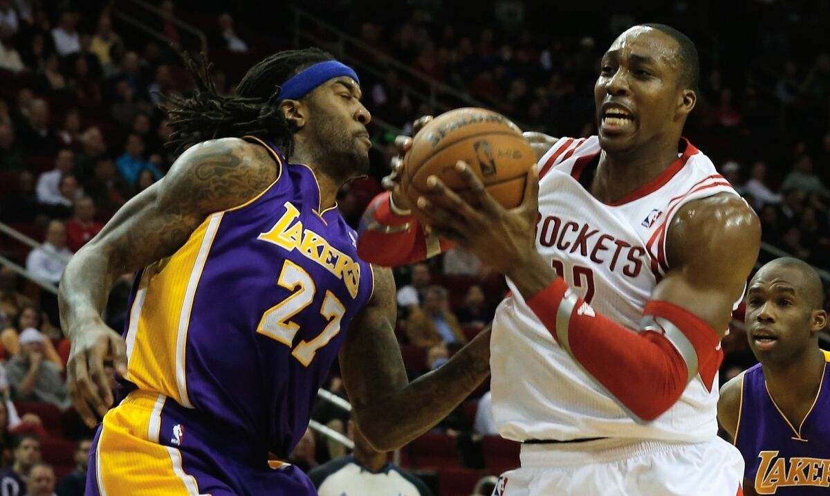 Rockets center Dwight Howard tries to drive past Lakers power forward Jordan Hill during a game earlier this season in Houston