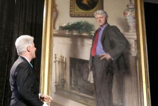 Former President Bill Clinton looks up at his portrait after removing the drape at the Smithsonian Castle Building in Washington in April, 2006.