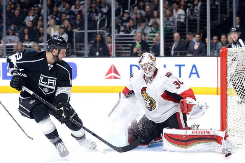 Kings left wing Kyle Clifford looks for a rebound shot after a save by Senators goaltender Andrew Hammond in the second period Thursday night at Staples Center.