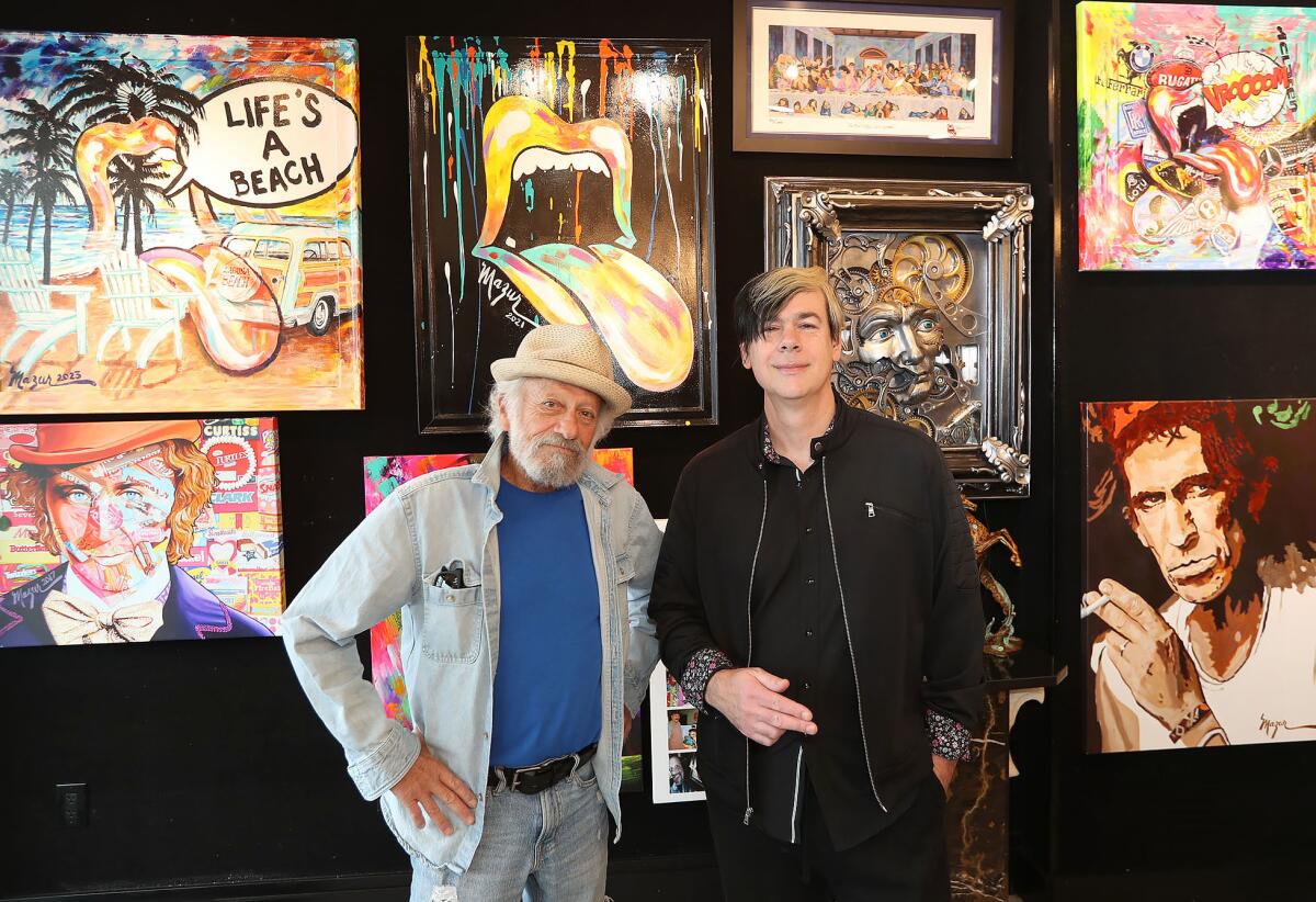 Artist Ruby Mazur and art consultant David Michael Vaughn, from left, stand in the Bill Mack Gallery in Laguna Beach.