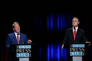 Georgia Gov. Brian Kemp, left, speaks during a gubernatorial republican primary debate toward Former Sen. David Perdue, right, on Sunday, May 1, 2022, in Atlanta. (AP Photo/Brynn Anderson, Pool)