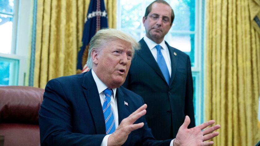 President Trump speaks to members of the media beside Alex Azar, the secretary of Health and Human Services, on July 1.