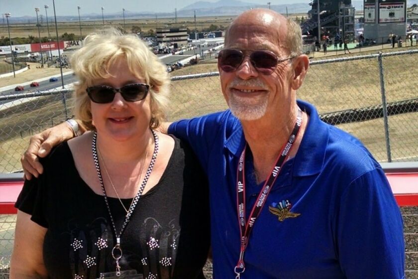 Kathy and Dave Burgemeister, shown embracing at a track, are longtime racing fans.