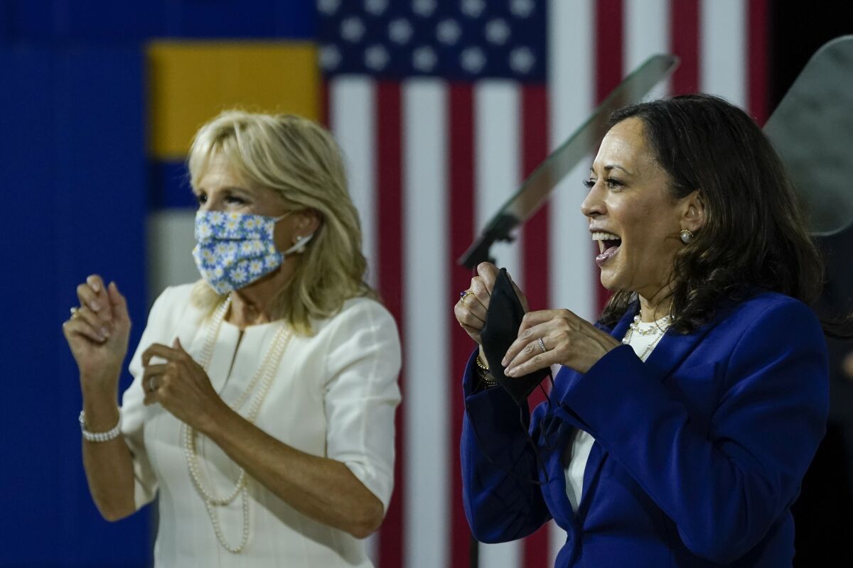 Jill Biden and Sen. Kamala Harris mingle at the end of an event introducing Harris as Joe Biden's running mate.