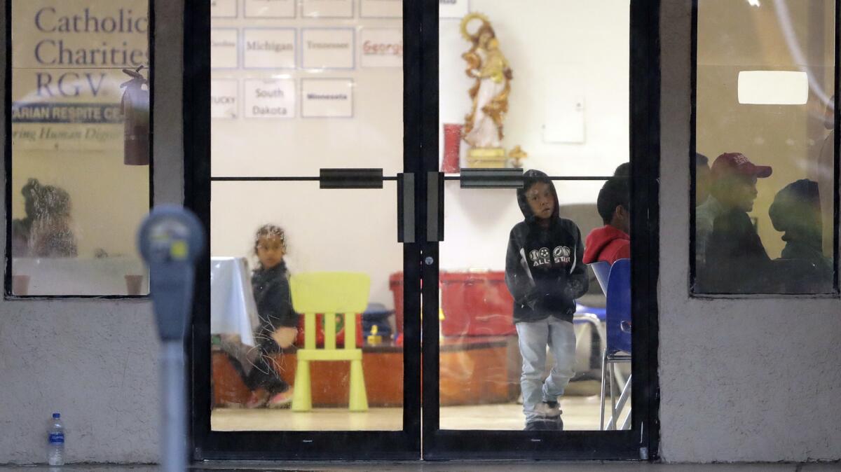 Immigrants recently processed and released by U.S. Customs and Border Protection wait at the Catholic Charities of the Rio Grande Valley in McAllen, Texas.