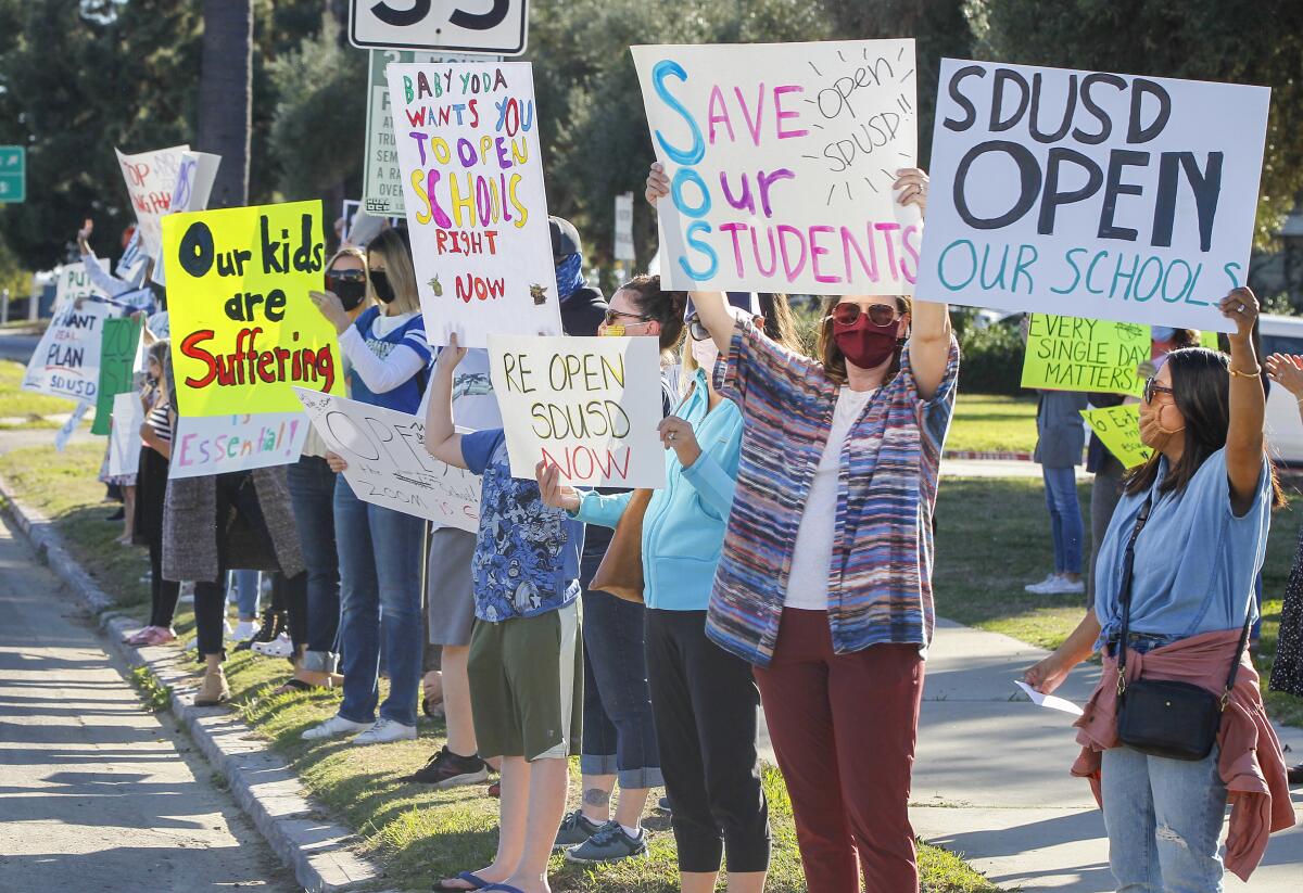 Parents and students rally to reopen schools outside the SDUSD Board of Education Headquarters