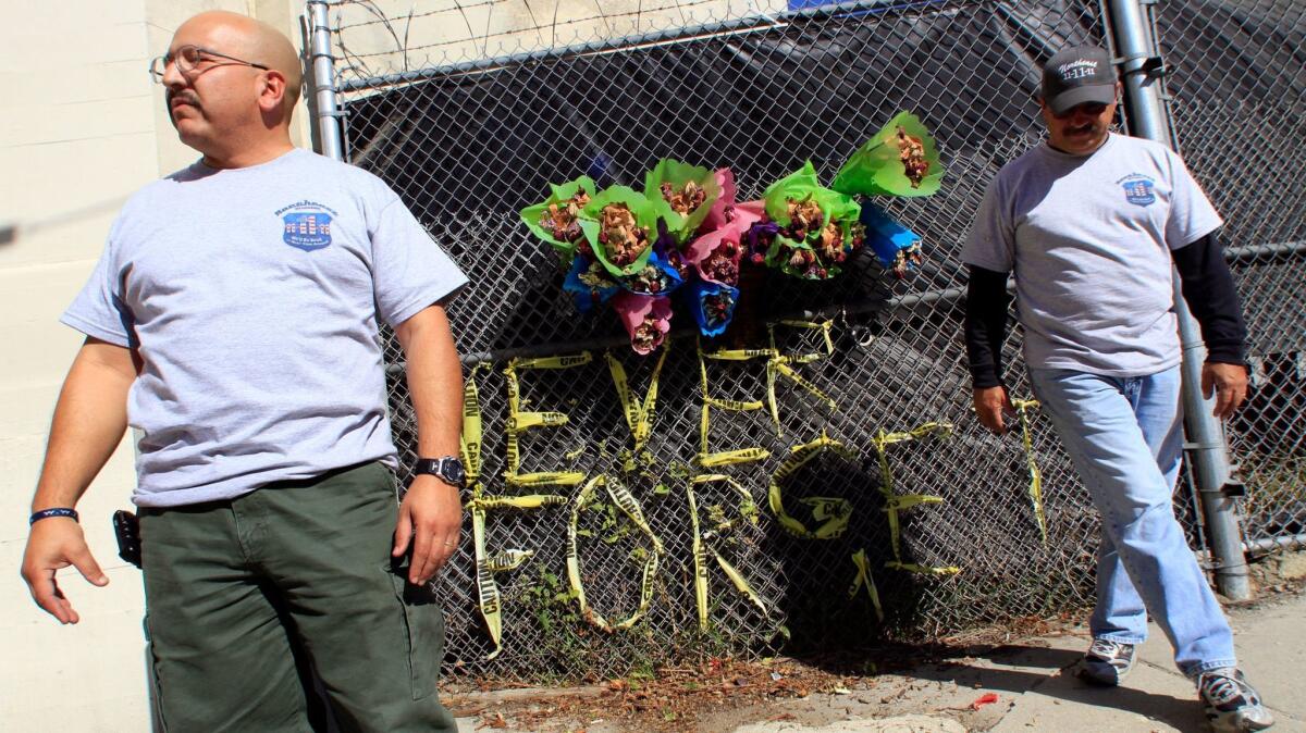 In 2011, LAPD officers J. C. Duarte, left, and Harold Marinelli tend to a memorial for an officer killed while assessing a traffic accident.