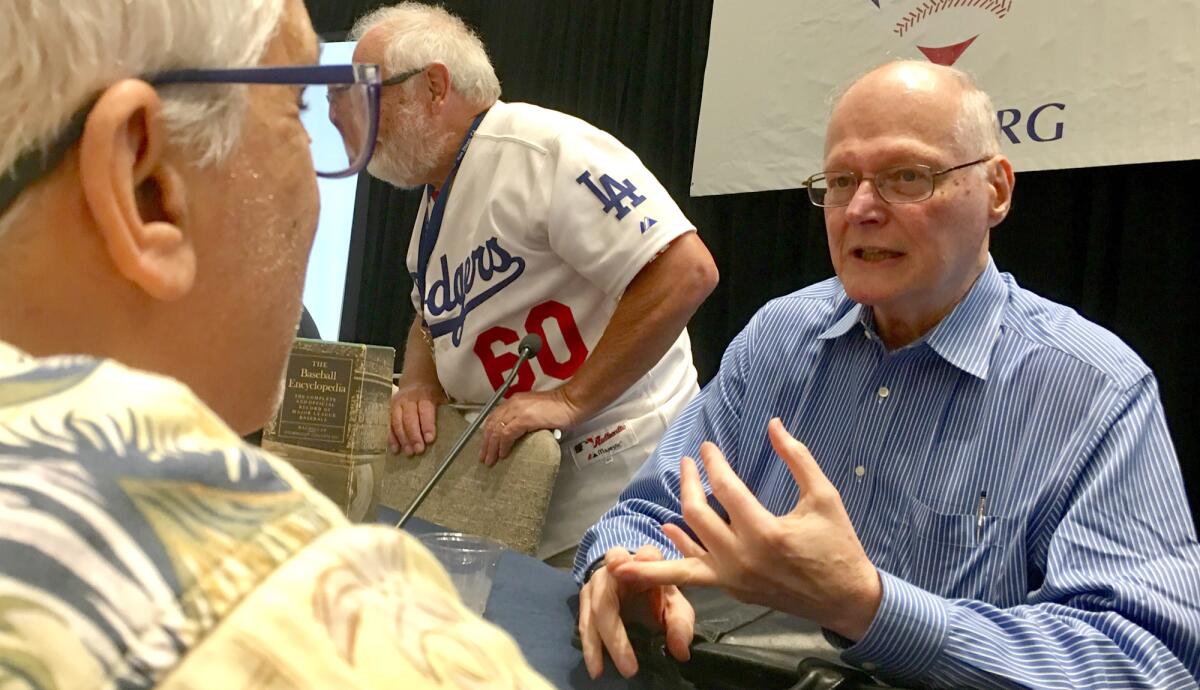 David Neft discusses how The Baseball Encyclopedia was created with an attendee at the SABR convention in San Diego on June 28, 2019.