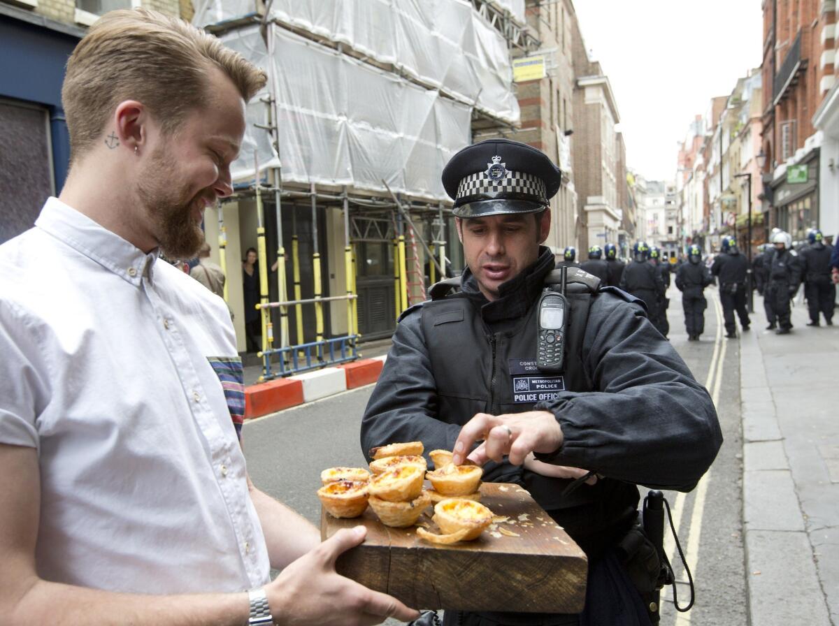 A London police officer samples wares offered by a local businessman. In Minnesota, a man was arrested and accused of shoplifting after taking a large number of samples from a grocery store.