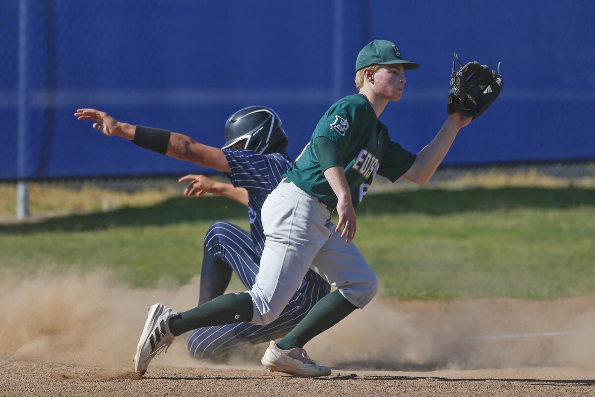 Newport Harbor's Dominic Viglione slides safely into third base as Edison's Noah Stockman waits for the throw on Friday.