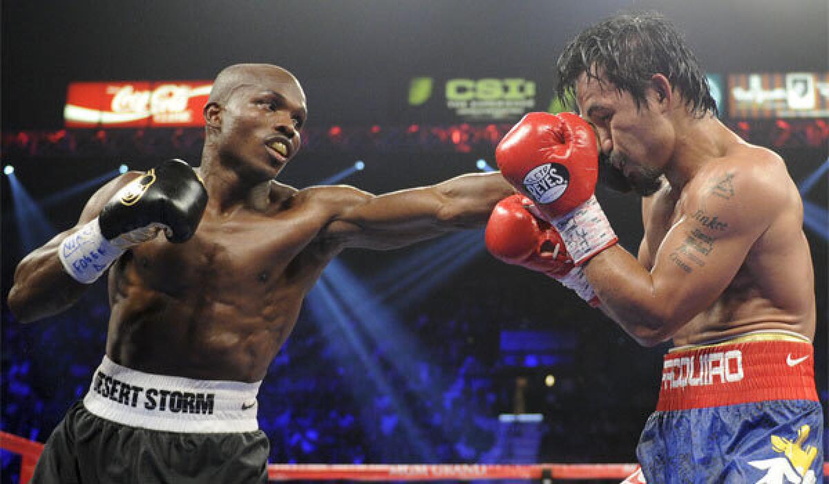 Timothy Bradley, left, lands a punch against Manny Pacquiao during their June 2012 WBO welterweight title fight in Las Vegas. Bradley won an unpopular split-decision, but he's looking for something more decisive in the rematch.