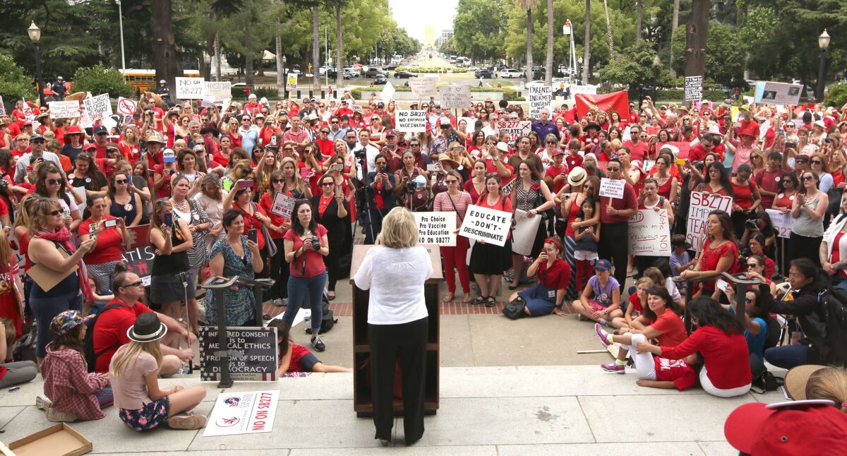 Barbara Loe Fisher, center, founder of the National Vaccine Information Center, speaks against SB 277, a measure requiring California schoolchildren to get vaccinated, at a Capitol rally.