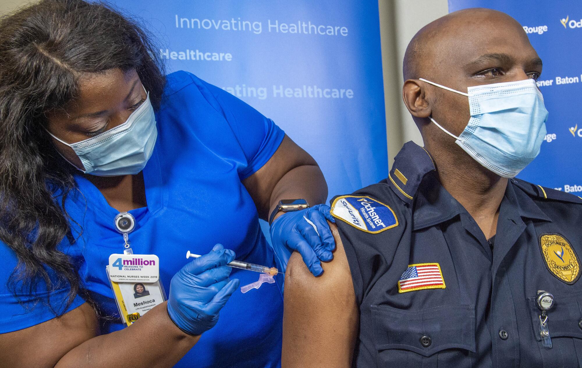 Lt. Ollie Martin is given the COVID-19 vaccine by nurse Meshoca Williams 
