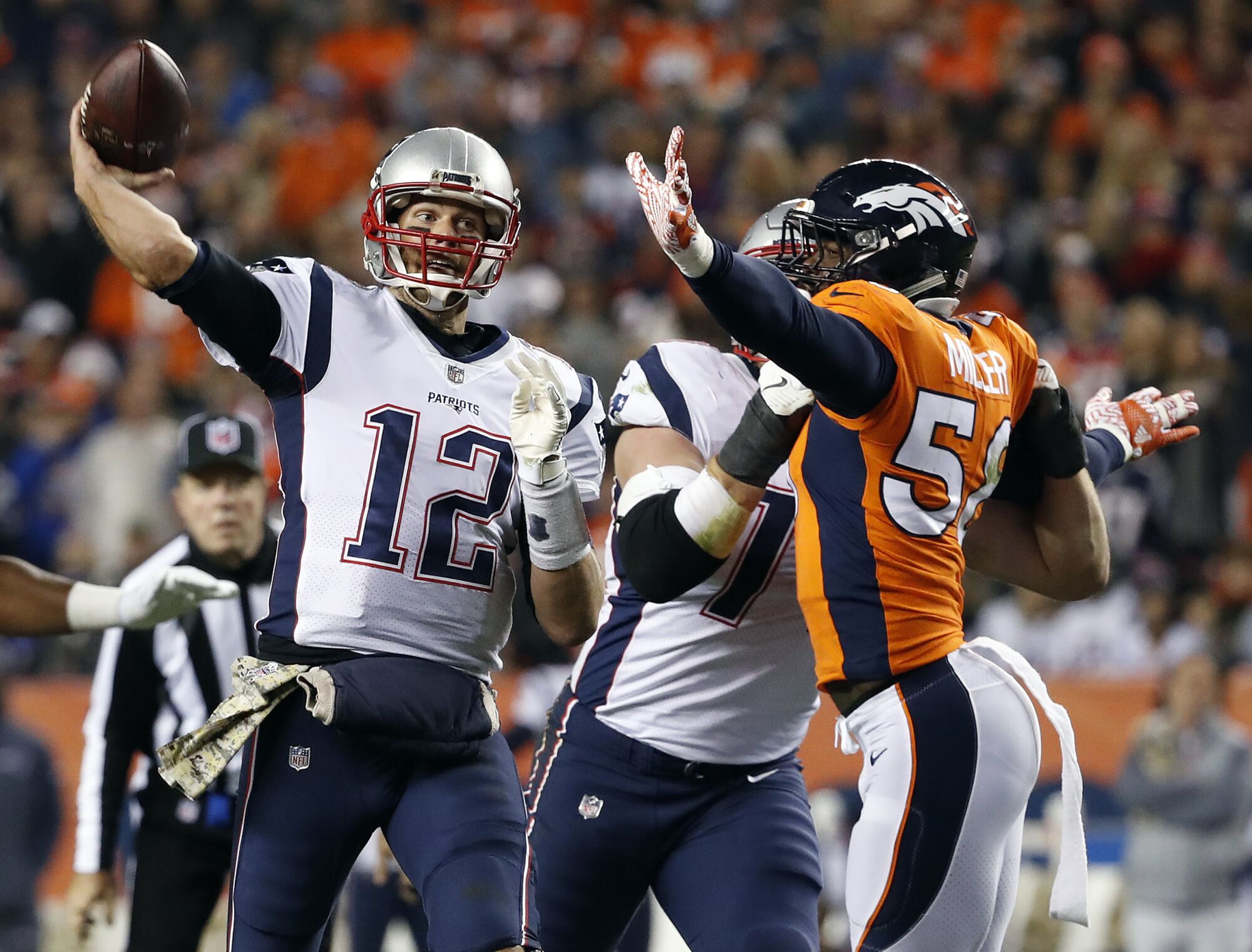 Broncos linebacker Von Miller pressures Patriots quarterback Tom Brady.