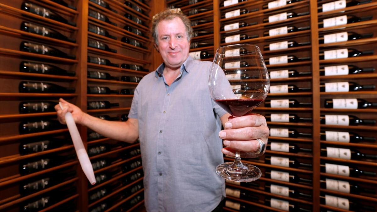 Urban Press Winery owner Giovanni D'Andrea shows off his barrel 2015 Merlot.