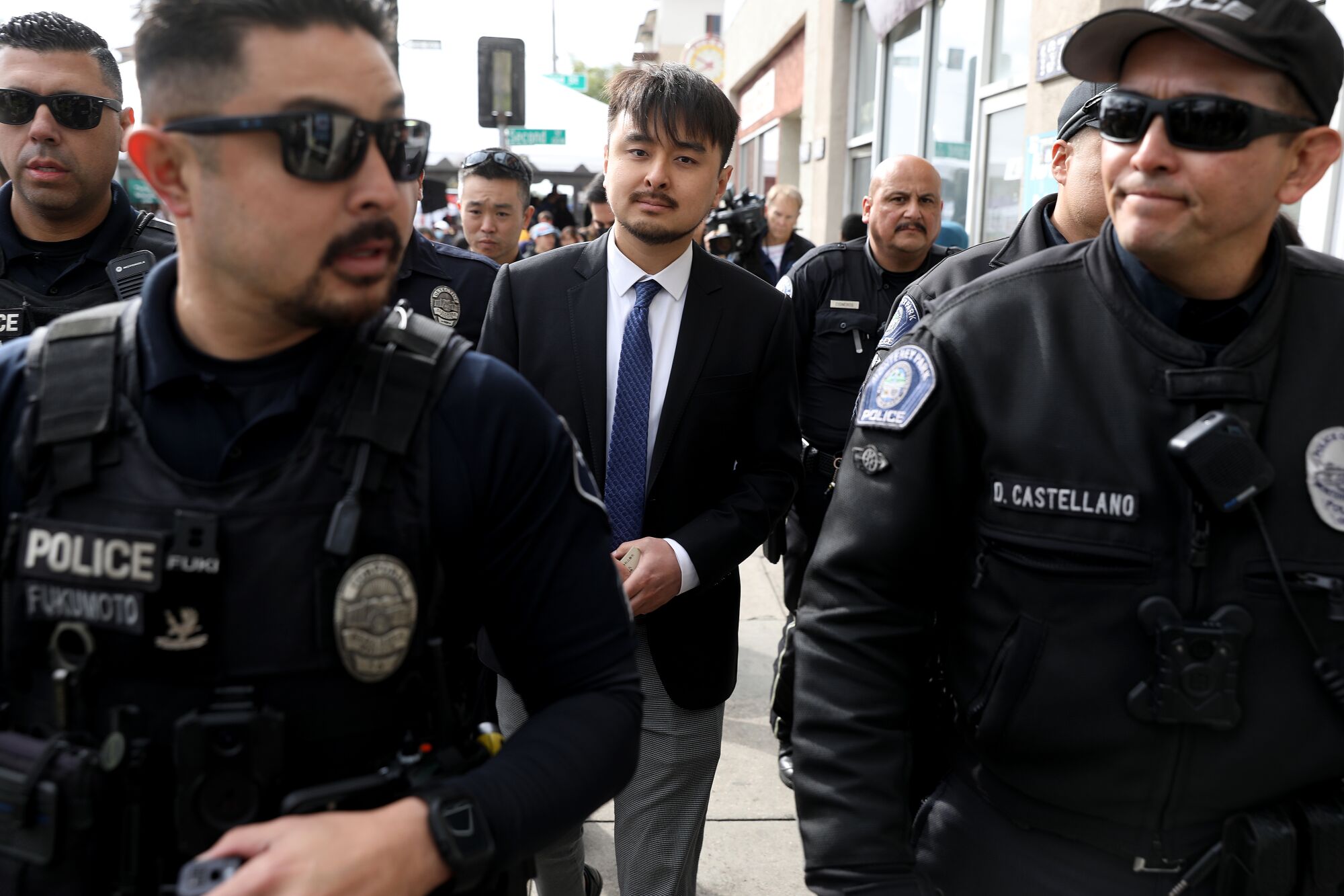 A man is surrounded by a police escort.