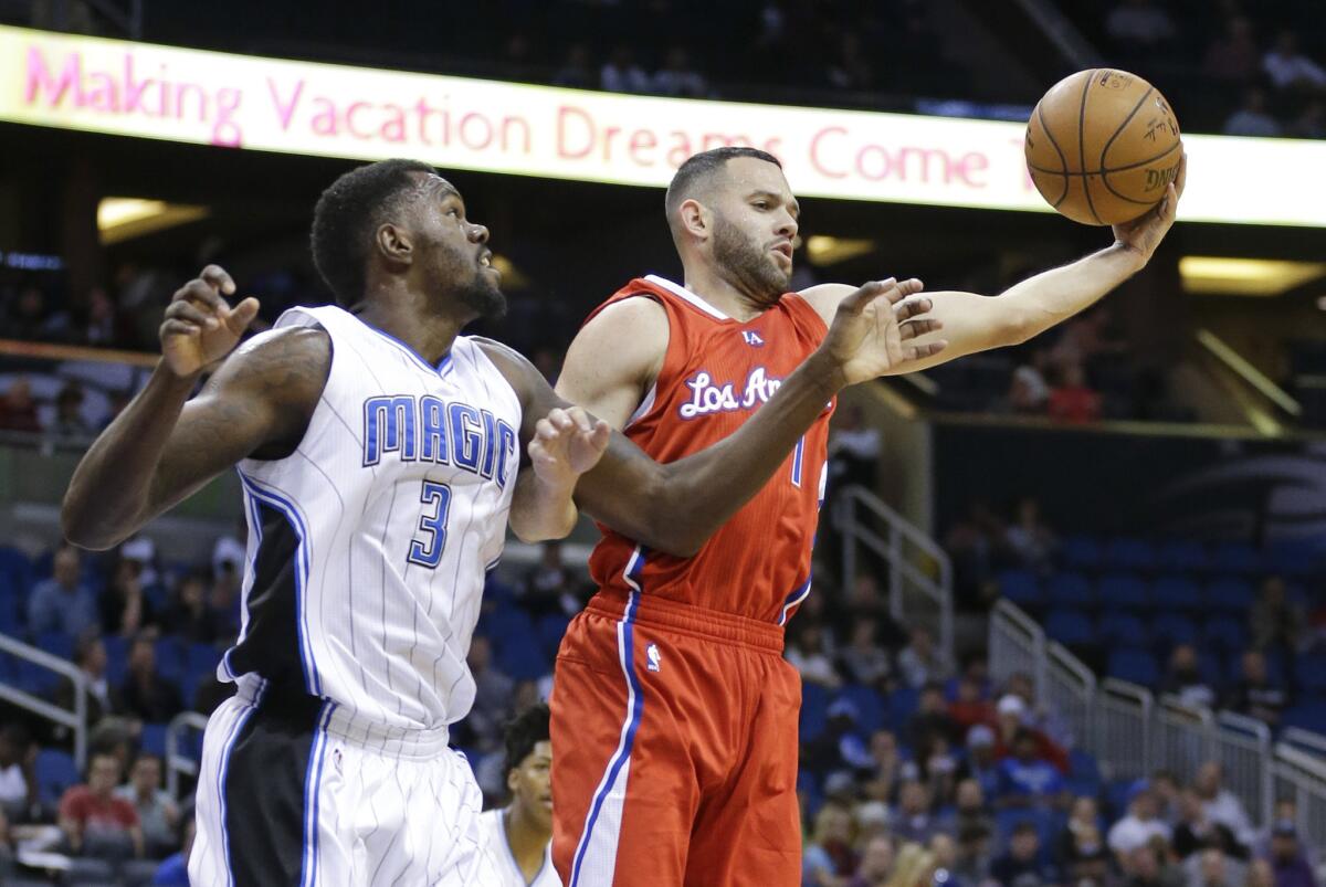 Jordan Farmar grabs a rebound away from Orlando's Dewayne Dedmon during the second half of the Clippers' 114-90 win over the Magic on Nov. 19.