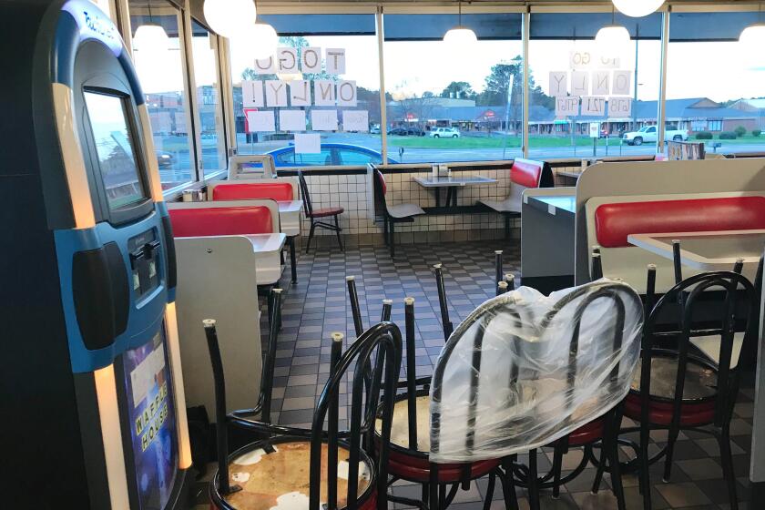 A Waffle House in Cartersville, Ga., is serving to-go only after the town's mayor signed a countywide emergency joint resolution Friday evening that closed all bars, dine-in restaurants and theaters. (Jenny Jarvie / Los Angeles Times)