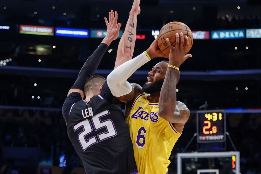 Lakers forward LeBron James tries to score against Kings center Alex Len.