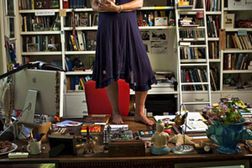 Cornelia Funke, best-selling author of the "Inkheart" series, at her Beverly Hills home -- on top of her desk with a stuffed dragon.