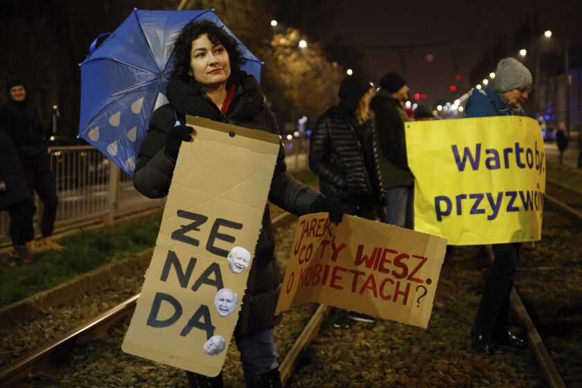 Manifestantes se reúnen frente a la casa del líder del partido gobernante de Polonia, Jaroslaw Kaczynski, en Varsovia, Polonia, el lunes 28 de noviembre de 2022. (AP Foto/Michal Dyjuk)