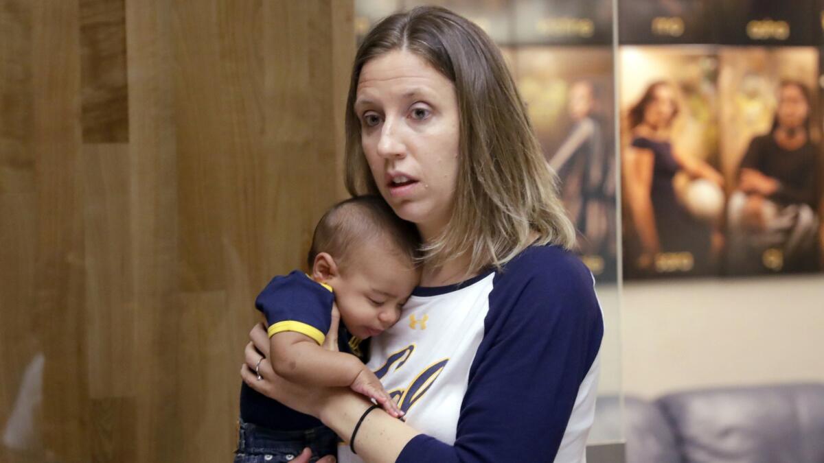 California women's basketball coach Lindsay Gottlieb holds her then-6-month-old son, Jordan, on Aug. 30.
