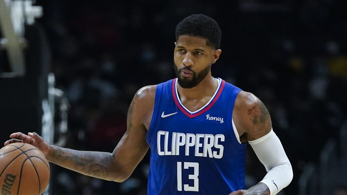 Clippers guard Paul George controls the ball during a game.