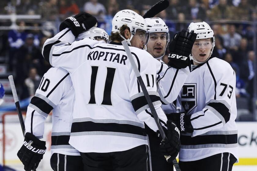 Kings defenseman Drew Doughty, second from right, is congratulated by teammates Mike Richards, left, Anze Kopitar and Tyler Toffoli after scoring during the first period of the Kings' 3-1 win over the Toronto Maple Leafs on Wednesday.