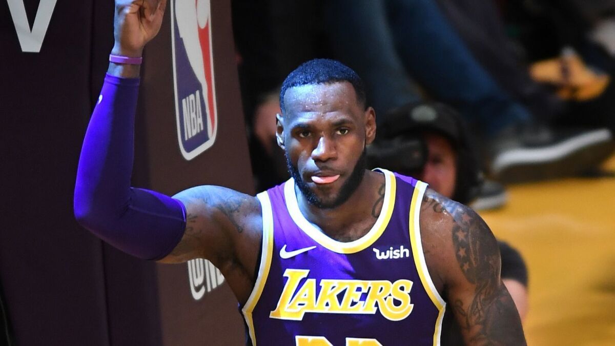 Lakers' LeBron James celebrates his basket against the Denver Nuggets as he passes Michael Jordan on the all-time scoring list Wednesday at Staples Center.