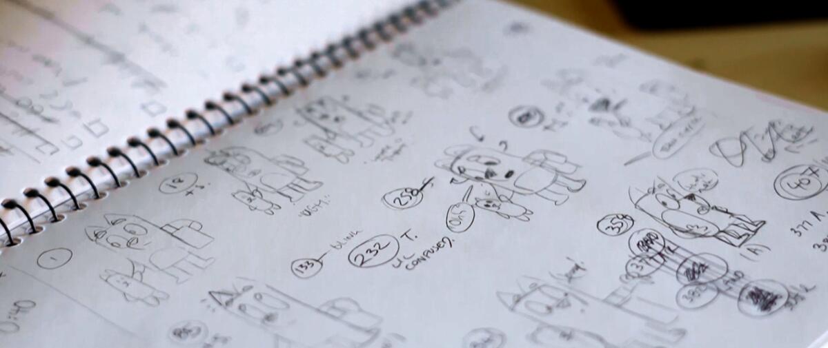 Line sketches of dogs on a spiral notebook.