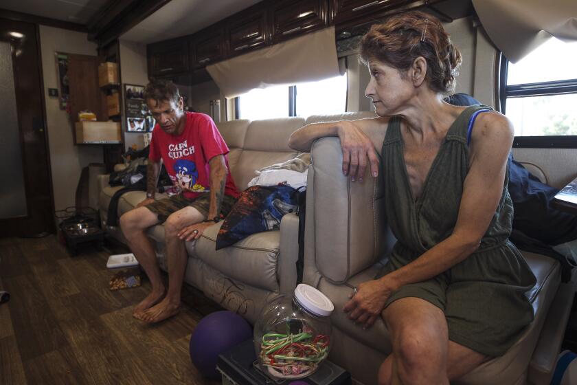 Cathy Sweetser and her friend Mark Someson sit inside her new RV that they live in while parked in a public parking lot in Mission Beach in San Diego on Tuesday, May 14, 2019 in San Diego, California. Sweetser said that she was unable to pay for the property taxes and upkeep of her house in El Cajon. So she sold the house and bought an RV as a way to live and make ends meet. She says she has money, but she's on a six month waiting list to get into an RV park. In the meantime they have to park in public parking lots that police tell them they cannot stay in.