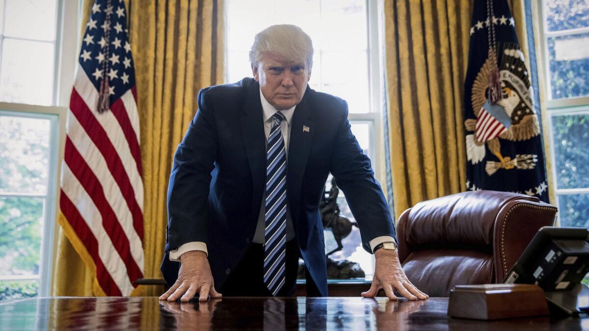President Trump poses for a portrait in the Oval Office in Washington on April 21, 2017.