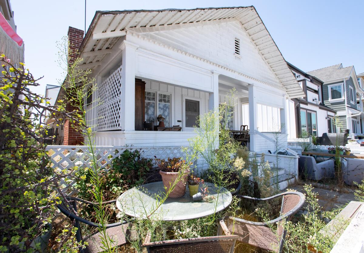 Weeds fill the yard of a home on Balboa Boulevard in Newport Beach.